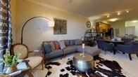 Located at 111 Gateway C in Chesapeake, Virginia, this single-floor residence offers a thoughtfully designed layout with comfortable living spaces and quality finishes throughout. The living room serves as the heart of the home, featuring elegant crown molding, warm neutral tones, and generous space for entertaining. The kitchen is equipped with rich honey-toned wood cabinetry, dark granite countertops, stainless steel appliances including a refrigerator, microwave, and dishwasher, and a peninsula that provides additional prep and dining space. The primary bedroom is a serene retreat with plush carpeting, wall sconces, and convenient access to a dedicated walk-in closet. A second bedroom offers natural light through dual windows dressed with decorative curtains, soft carpeting, and ample space for rest or versatile use. The bathrooms are finished with warm wood vanities, white countertops, large mirrors, and stone-look tile flooring, creating a clean and functional aesthetic. The overall ambiance of the residence is warm and inviting, with a cohesive neutral palette and tasteful detailing that lends a comfortable, well-maintained character to every room.
