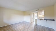 Located at 744 Spring West Rd in Orlando, FL, this one-bedroom, one-bathroom unit offers a well-organized, single-floor layout designed to maximize functionality. The open-concept living and dining area is bright and welcoming, featuring wood-look flooring, neutral cream-toned walls, and a textured ceiling. A large window frames a serene water view, filling the space with natural light. A sliding glass door provides direct access to the private patio, offering additional outdoor living space.

The kitchen is efficiently designed with white cabinetry, granite countertops, a peninsula breakfast bar that opens to the living area, and wood-look flooring that carries through from the main living space. Appliances include a full-size refrigerator and range.

The bedroom features carpeted flooring, a sliding glass door with outdoor views, built-in open shelving for convenient storage, and access to a dedicated closet. The bathroom is finished with granite countertops, white cabinetry with brushed nickel hardware, wood-look flooring, a large vanity mirror, and a combined tub and shower. Throughout the unit, consistent finishes and a clean, neutral palette create a cohesive and comfortable living environment.