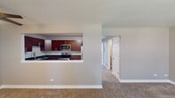 Located at 19 Briar St in Glen Ellyn, IL, this single-floor unit offers a well-organized layout with a cohesive neutral palette throughout. The living area is generously sized, featuring plush carpeting, a ceiling fan, and a large window that allows natural light to fill the space. A wall-mounted air conditioning unit provides supplemental climate control, complementing the baseboard heating found throughout the unit.

The kitchen is a standout feature, designed with rich cherry wood cabinetry, sleek bar-pull hardware, and deep granite countertops. Stainless steel appliances—including a range, microwave, and dishwasher—add a modern touch, while a pass-through opening connects the kitchen to the living area, promoting an open, communicative flow.

The bedrooms are carpeted and finished in warm neutral tones. One bedroom includes a walk-in closet alongside a standard closet, as well as a window with natural views and a wall-mounted air conditioning unit. Additional bedrooms are well-proportioned with ample wall space and baseboard heating.

The bathroom features wood-look tile flooring, a tub-shower combination with white tile surround, brushed nickel accessories, and a vanity with storage. The overall ambiance of the space is clean, functional, and move-in ready.