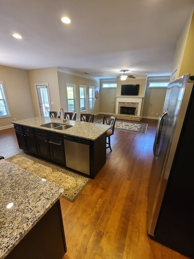 Kitchen open to the great room. - 3624 Foxtrot Trl NW