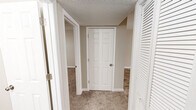Located at 3132 Carousel Ct in Hoover, Alabama, this one-bedroom, one-bathroom home offers a well-organized, single-floor layout designed for efficient everyday living. The kitchen is a standout feature, showcasing crisp white shaker-style cabinetry, granite countertops with subtle veining, a stainless steel sink, and a peninsula that provides additional prep space. Wood-look plank flooring runs throughout the kitchen and main living areas, lending a clean and contemporary feel. The bedroom is a comfortable, well-proportioned space with plush carpeting, neutral beige walls, and a window that allows natural light and views of surrounding greenery. It includes access to a dedicated closet, while a second closet is conveniently located in the hallway, providing ample storage throughout. The hallway connects the rooms efficiently, featuring carpet underfoot and louvered closet doors that add a classic touch. The bathroom is finished in light, neutral tones with wood-look tile flooring, a white vanity with modern hardware, and a full tub/shower combo. Textured ceilings are consistent throughout, and the warm, neutral color palette creates a cohesive and inviting ambiance across the entire home.