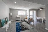 Located at 331 S Sunrise Way in Palm Springs, California, this single-floor unit offers a bright and modern interior finished with consistent light wood-tone luxury vinyl plank flooring throughout. The open-concept living and dining area serves as the heart of the home, featuring recessed lighting, a textured ceiling, and a sliding glass door that brings in natural light and provides access to a balcony. A ceiling fan adds comfort to the dining area, which flows seamlessly from the living space. The galley-style kitchen is well-appointed with white shaker cabinetry, dark quartz countertops, stainless steel appliances including a refrigerator, electric range, and microwave, as well as a double basin sink — offering an efficient and functional layout. The bedrooms are comfortably sized, each featuring a ceiling fan with light fixture, a window with blinds for natural light and privacy, and neutral gray walls that create a calm atmosphere. The bathroom is finished with white shaker-style cabinetry, dark quartz countertops, an undermount sink, brushed nickel fixtures, and a clean, crisp color palette. The unit presents a cohesive, contemporary aesthetic throughout, ideal for those seeking a move-in ready home in the desert community of Palm Springs.