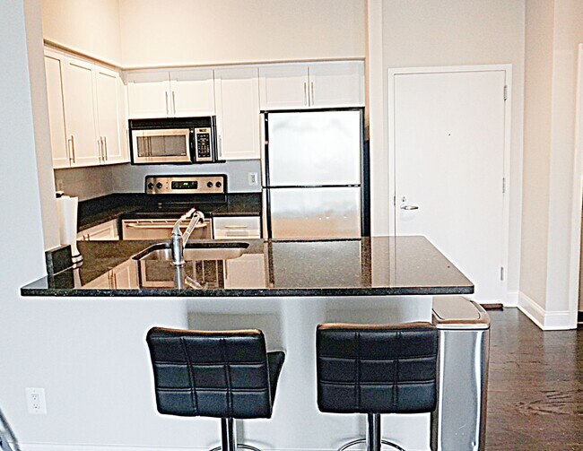 Building Photo - A Modern Living of Top-Level Unit in the C...