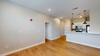 Located at 400 W Washington St in Muncie, Indiana, this thoughtfully designed one-bedroom, one-bathroom unit offers a clean, contemporary aesthetic with modern finishes throughout. Warm hardwood-style flooring flows seamlessly across the entire single-level layout, creating a cohesive and inviting atmosphere.

The open-concept kitchen serves as a central highlight, featuring white shaker cabinetry, light quartz countertops, a tile backsplash, and a full suite of stainless steel appliances including a refrigerator, range, microwave, and dishwasher. A peninsula with pendant lighting overhead provides additional prep space and a natural divide between the kitchen and the living area, which benefits from natural light through a large window.

The bedroom is a well-proportioned retreat with a ceiling fan, a generously sized closet, and a window that brings in natural light. Three closets across the unit offer excellent storage capacity. The bathroom is finished with a white vanity with quartz countertop, a bold black-framed mirror, and a combination tub and shower. A dedicated laundry area and an in-unit electrical panel add to the practicality of the space. Recessed lighting and clean neutral walls complete the modern, move-in-ready feel of this well-appointed unit.