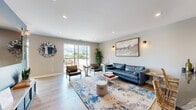 Located at 440 Green Bay Rd in Highwood, Illinois, this thoughtfully designed single-floor entertainment and lounge space offers a dynamic blend of comfort, style, and recreation. Light hardwood flooring flows throughout, tying together distinct zones that each serve a unique social purpose.

Upon entry, a bold blue accent wall with a large wall-mounted mirror and a sleek console table set a modern, welcoming tone. Warm wall sconces and recessed lighting provide layered illumination throughout. The lounge area features a blue leather sofa, leather accent chairs, a marble coffee table, and a colorful area rug, all arranged around a large flat-screen TV — perfect for relaxed gatherings.

A dedicated game area accommodates a full-size pool table beneath a striking slatted pendant light, with vibrant artwork adorning the surrounding walls. Adjacent to this is a well-appointed bar area with counter seating, pendant lighting, and bold, colorful artwork that energizes the space.

Natural light pours in through large windows and a sliding glass door that opens to an outdoor terrace, extending the entertaining footprint beyond the interior. The overall ambiance is modern and inviting, with cohesive design elements — from the carefully chosen décor to the thoughtful layout — making this a versatile space well-suited for both lively events and casual lounging.