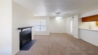 Located in Waco, TX, this single-story 2-bedroom, 2-bathroom home offers a practical and comfortable layout designed for efficient everyday living. The living room serves as the heart of the home, featuring a striking dark-surround wood-burning fireplace, a ceiling fan with light kit, textured ceilings, neutral carpet flooring, and a window that brings in natural light, creating a warm and inviting atmosphere. Adjacent to the living area, the galley-style kitchen is equipped with warm oak cabinetry, white appliances including an electric range and refrigerator, a stainless steel sink, and durable wood-look flooring — providing ample storage and workspace. A dedicated laundry area and multiple closets add to the home's functional appeal. The primary bedroom is generously proportioned, featuring plush carpet, a ceiling fan, a window for natural light, and direct access to its own bathroom with an oak vanity. The second bedroom mirrors this comfort with carpet flooring, a ceiling fan, and a natural light-filled window. Both bathrooms include oak cabinetry, wood-look flooring, and full tub-shower combinations. Three closets throughout the home ensure plentiful storage. The consistent use of neutral tones and warm wood accents gives the entire space a cohesive, livable character.