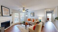 Located at 347 Shadow Creek Ln in Anderson, South Carolina, this well-appointed 2-bedroom, 2-bathroom home offers a thoughtfully designed single-floor layout that balances comfort and functionality. The inviting living room serves as the heart of the home, featuring rich hardwood floors, a ceiling fan with light fixture, a tiled fireplace as a focal point, and a glass door that opens to an outdoor area, allowing natural light to pour in. Adjacent to the living room, the dining area provides an intimate setting highlighted by an elegant chandelier and classic wainscoting detail. The galley-style kitchen is equipped with white cabinetry, granite-look countertops, black appliances, and hardwood flooring, with direct access to a dedicated in-unit laundry room housing a full-size washer and dryer. The spacious primary bedroom features plush carpeting, a ceiling fan, a walk-in closet, and a bright window with outdoor views. The second bedroom is equally comfortable with similar finishes. Both bathrooms offer tub-shower combinations and vanities with granite-style countertops. Three closets throughout the home ensure ample storage. The overall ambiance is warm, bright, and move-in ready.
