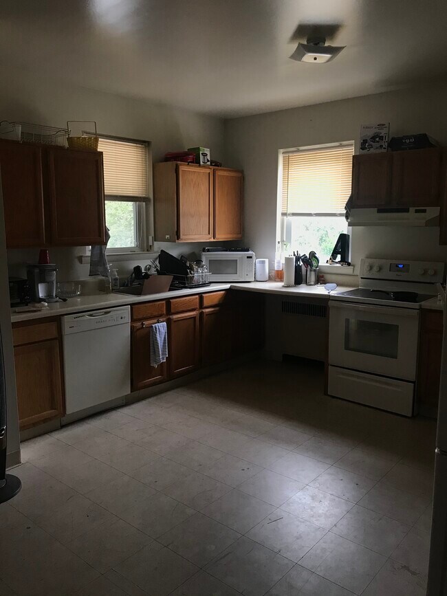 The kitchen comes with an oven, dishwasher, microwave, and cooking utensils. - 2401 N 57th St