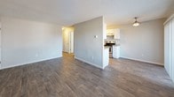 This single-floor unit offers a practical and updated layout designed for comfortable everyday living. The open-concept living area is finished with durable wood-look laminate flooring and a textured ceiling, with natural light filtering in through a large window that offers outdoor views. A ceiling fan adds to the functionality of the space, and the layout flows naturally toward the kitchen.

The galley-style kitchen is well-equipped with stainless steel appliances, including a refrigerator and electric range, set against crisp white cabinetry and gray laminate countertops. A tile mosaic backsplash adds a decorative accent, while wood-look flooring continues throughout for a cohesive look.

The bedrooms feature plush carpeting and are each equipped with baseboard heating. Windows in each room bring in natural light and views of the surrounding greenery, creating a calm and comfortable atmosphere. Interior doors provide privacy between the sleeping areas and common spaces.

The bathroom is finished with wood-look vinyl flooring, a white vanity with a gray countertop, a large mirror, and a tiled backsplash that coordinates with the kitchen. A full shower enclosure and a towel bar complete the clean, functional design. Overall, the unit presents a neutral, move-in-ready aesthetic throughout.