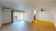 Located at 300 Rolling Oaks Dr in Thousand Oaks, CA, this well-designed 2-bedroom, 2-bathroom residence offers a comfortable single-level layout. The bright and open living room features light hardwood-style flooring, clean white walls, and a ceiling fan, with large sliding glass doors that lead to a private balcony overlooking mature trees — filling the space with natural light and greenery views. The kitchen is efficiently designed with white cabinetry, dark granite-style countertops, stainless steel appliances including a full-size refrigerator, and a window that brings in additional natural light. Both bedrooms are carpeted and generously sized, with the primary bedroom offering a spacious footprint and its own sliding glass door to a second private balcony, as well as a wall-mounted mini-split AC unit for individualized climate control. The second bedroom features a bright window with pleasant outdoor views. The two bathrooms are finished with white cabinetry, dark countertops, and warm hardwood-style flooring, with one bath featuring a full tub and shower combination. A connecting hallway ties the layout together seamlessly, creating a cohesive and functional living environment throughout.