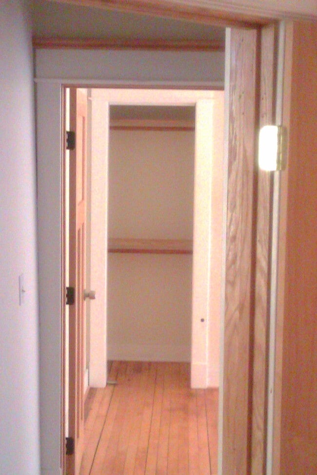 Hallway into Bedroom #2. Craftily placed over the closet recessed storage and all closet have lights in them. Dual level clothes in rack - 1016 Iglehart Ave