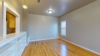 Located at 1201 Winkler Ave in Killeen, Texas, this two-story home offers a functional and well-organized layout across both floors. The living and dining areas feature polished light hardwood flooring that reflects natural light from multiple windows fitted with blinds, creating a bright and welcoming atmosphere. Pendant and flush-mount ceiling fixtures provide consistent overhead lighting throughout. The galley-style kitchen is equipped with light wood cabinetry, white appliances including a range and refrigerator, a double sink, and tile flooring — offering an efficient and practical cooking space. A hallway connects the kitchen to additional rooms and bathrooms. The bedrooms are finished with plush carpet flooring in neutral tones and are illuminated by natural light through windowed walls. Each bedroom provides a calm, comfortable environment with clean, neutral-toned walls. Two full bathrooms are present in the home, each featuring tile flooring, a tub-shower combination, a toilet, and overhead cabinetry for storage. The consistent use of neutral gray and beige tones throughout the home creates a cohesive and understated aesthetic. Overall, 1201 Winkler Ave presents a clean, move-in-ready space with practical finishes suited for everyday living.