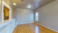 Located at 1201 Winkler Ave in Killeen, Texas, this two-story home offers a functional and well-organized layout across both floors. The living and dining areas feature polished light hardwood flooring that reflects natural light from multiple windows fitted with blinds, creating a bright and welcoming atmosphere. Pendant and flush-mount ceiling fixtures provide consistent overhead lighting throughout. The galley-style kitchen is equipped with light wood cabinetry, white appliances including a range and refrigerator, a double sink, and tile flooring — offering an efficient and practical cooking space. A hallway connects the kitchen to additional rooms and bathrooms. The bedrooms are finished with plush carpet flooring in neutral tones and are illuminated by natural light through windowed walls. Each bedroom provides a calm, comfortable environment with clean, neutral-toned walls. Two full bathrooms are present in the home, each featuring tile flooring, a tub-shower combination, a toilet, and overhead cabinetry for storage. The consistent use of neutral gray and beige tones throughout the home creates a cohesive and understated aesthetic. Overall, 1201 Winkler Ave presents a clean, move-in-ready space with practical finishes suited for everyday living.