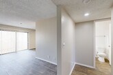 Located at 3324 S Field St in Lakewood, Colorado, this one-bedroom, one-bathroom unit offers a well-designed, efficient layout across a single floor. The combined kitchen and living area forms the heart of the home, where wood-style flooring, neutral walls, and a textured ceiling create a clean, modern aesthetic. The living room is bright and airy, benefiting from a large sliding glass door fitted with vertical blinds that opens to an outdoor area, alongside an additional window that draws in natural light. A ceiling fan adds comfort and functionality to the space.

The galley-style kitchen is well-appointed with crisp white cabinetry featuring sleek bar-pull hardware, marble-look countertops, a subway tile backsplash in a soft blue-gray tone, and stainless steel appliances including a refrigerator and dishwasher. Light wood-tone flooring ties the kitchen seamlessly into the living area.

The bedroom is generously proportioned, finished with plush carpeting and a window that provides natural light. It offers direct access to both a full bathroom and a dedicated closet with built-in storage. The bathroom features white cabinetry, a wide vanity with a marble-look countertop, brushed nickel fixtures, and wood-style tile flooring, delivering a clean and contemporary finish throughout.