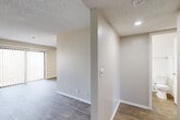 Located at 3324 S Field St in Lakewood, Colorado, this one-bedroom, one-bathroom unit offers a well-designed, efficient layout across a single floor. The combined kitchen and living area forms the heart of the home, where wood-style flooring, neutral walls, and a textured ceiling create a clean, modern aesthetic. The living room is bright and airy, benefiting from a large sliding glass door fitted with vertical blinds that opens to an outdoor area, alongside an additional window that draws in natural light. A ceiling fan adds comfort and functionality to the space.

The galley-style kitchen is well-appointed with crisp white cabinetry featuring sleek bar-pull hardware, marble-look countertops, a subway tile backsplash in a soft blue-gray tone, and stainless steel appliances including a refrigerator and dishwasher. Light wood-tone flooring ties the kitchen seamlessly into the living area.

The bedroom is generously proportioned, finished with plush carpeting and a window that provides natural light. It offers direct access to both a full bathroom and a dedicated closet with built-in storage. The bathroom features white cabinetry, a wide vanity with a marble-look countertop, brushed nickel fixtures, and wood-style tile flooring, delivering a clean and contemporary finish throughout.