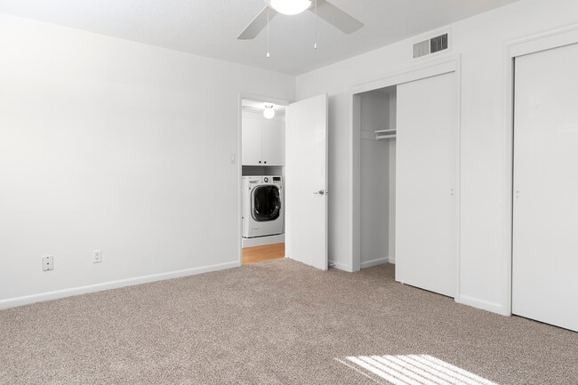 Bedroom features dual closets and carpet in select units - Skylar Apartments