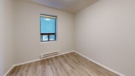 Located at 223 Woodbine Ave in Toronto's vibrant east end, this one-bedroom, one-bathroom unit offers a practical and efficiently designed floor plan across a single level. Light wood-style vinyl flooring flows throughout the living spaces, creating a cohesive and clean aesthetic complemented by neutral white and grey walls.

The living room provides a comfortable open area with ample wall space and natural light, while the entryway offers a seamless transition into the unit. The bedroom is a well-proportioned private retreat featuring a window with natural light, a baseboard heater, and direct access to two closets for generous storage.

The kitchen is thoughtfully equipped with white shaker-style cabinetry, granite-look countertops, white tile backsplash, stainless steel appliances including an electric range with an over-the-range microwave, and a window for ventilation. Tile flooring grounds the kitchen space functionally.

The bathroom features full white subway tile surrounding a soaker tub with shower, complemented by a window, providing a bright and clean finish. Textured ceilings are present throughout the unit, adding a subtle classic character. Two closets enhance the overall storage capacity of this cozy yet functional home.