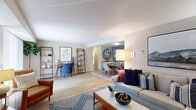 Located at 2 Rolling Green Dr in Milford, MA, this single-floor, two-bedroom, two-bathroom residence offers a practical and comfortable layout across a generously sized footprint. The open-concept living and dining area serves as the heart of the home, featuring light hardwood-style flooring that flows seamlessly throughout. The living room provides ample space for relaxed seating arrangements, while the adjacent dining area accommodates everyday meals and entertaining.

The kitchen is equipped with warm oak cabinetry, light granite-style countertops, and stainless steel appliances, including a full-size refrigerator, providing functional workspace and plentiful storage.

The spacious primary bedroom features plush carpeting, natural light from a window, and access to a closet with wire shelving. The second bedroom is similarly comfortable. Both bathrooms are finished with white cabinetry vanities, updated light fixtures, and shower-tub combinations, presenting a clean, bright aesthetic.

Three closets are distributed throughout the unit, offering practical storage solutions. The overall design maintains a neutral color palette with consistent finishes, creating a cohesive and inviting atmosphere throughout the home.