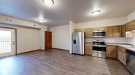 Located at 2040 Prairie Rose Dr in Mankato, MN, this three-bedroom, two-bathroom unit offers a well-designed, single-floor layout. The open-concept kitchen and living area serves as the heart of the home, featuring warm oak cabinetry, granite-style countertops, and a full suite of stainless steel appliances including a side-by-side refrigerator with ice and water dispenser, an electric range, built-in microwave, and dishwasher. Durable hardwood-style flooring runs throughout the main living areas, adding a clean and cohesive aesthetic.

The three bedrooms are comfortably sized, with the primary bedroom offering ample space, and all bedrooms feature plush carpeting and windows that bring in natural light with outdoor views. Four closets throughout the unit provide generous storage. The two bathrooms are finished with oak vanities, white countertops, and a full tub-shower combination. Rich wood-toned interior doors with classic panel detailing add a warm, consistent design touch throughout.

Additional highlights include a private balcony accessible via a sliding glass door, an in-unit laundry area, and a dedicated utility room. The unit offers a practical and comfortable living environment with thoughtful layout efficiency.