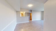 Located at 600 Island Shores Drive in Greenacres, Florida, this single-floor residence offers 2 bedrooms and 3 bathrooms within a thoughtfully designed layout. The open-concept living area features large neutral-toned ceramic tile flooring, a textured ceiling, and a seamless connection to the kitchen via a raised breakfast bar peninsula. The kitchen is equipped with wood-toned cabinetry and white appliances, with a pantry providing additional storage.

The bedrooms feature wood-look tile flooring and warm neutral walls with textured ceilings. The spacious primary bedroom includes direct access to a well-appointed en-suite bathroom, which showcases a corner vanity with herringbone-patterned tile backsplash, modern wood-grain cabinetry, white quartz-style countertops, and a tub-shower combination with large-format tile surround. The second bedroom benefits from a generous closet and a large window offering views of the surrounding greenery. Additional bathrooms echo the clean, modern finishes found throughout the home, featuring tiled tub-shower combinations and updated vanities. A hallway and dedicated closet space contribute to practical storage throughout this well-maintained Greenacres residence.