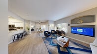 Located at 2121 E Warm Springs Rd in Las Vegas, NV, this 2-bedroom, 2-bathroom residence offers a thoughtfully designed single-floor layout that balances comfort and functionality. The open-concept living and dining area is anchored by wood-style flooring, a ceiling fan, and large windows that invite natural light and outdoor views. A built-in arched niche provides a decorative focal point alongside a wall-mounted TV, while direct access to an outdoor area adds convenience.

The kitchen is well-equipped with white shaker cabinetry, white quartz countertops, a subway tile backsplash, and a full suite of stainless steel appliances including a refrigerator, range, microwave, and dishwasher. A peninsula with bar seating and a skylight above creates a bright, social cooking space.

The primary bedroom is generously sized, featuring a ceiling fan, wood-style flooring, and access to natural light. The secondary bedroom also includes a ceiling fan and a walk-in closet. Each bathroom is distinctly designed — one with a soaking tub and shower combination, and the other with a glass-enclosed walk-in shower — both finished with white vanities and wood-style tile flooring. Two closets provide ample storage throughout the residence.
