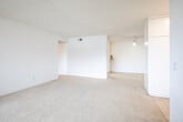 Located at 17101 Springdale Street in Huntington Beach, California, this one-bedroom, two-bathroom residence offers a well-organized, single-floor layout with a bright and neutral aesthetic throughout. The open-concept living, dining, and kitchen area forms the heart of the home, with plush carpeting in the living and dining spaces flowing naturally toward a sliding glass door that opens onto a private balcony with pleasant neighborhood views and natural greenery. The galley-style kitchen is efficiently designed, featuring white cabinetry, granite-style laminate countertops, a deep white sink, tile flooring, and a paneled ceiling light fixture that provides ample illumination. A pantry adds convenient additional storage. The bedroom is a comfortable, carpeted retreat with its own sliding glass door to the balcony, vertical blinds for light control, and access to two generous closets, including a walk-in style space with a hanging rod and shelving. The two bathrooms include a full bath with a soaking tub and shower combination finished in clean white surround, and a second bath featuring a wide vanity with a granite-style countertop, an undermount sink, and a large mirror with overhead lighting. Utility rooms provide practical storage, completing this functional and well-appointed Huntington Beach residence.