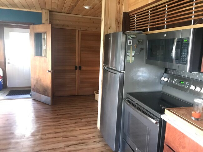 Kitchen with newer appliances including refrigerator - 202 Division St S