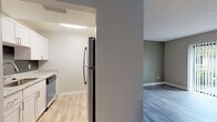 Located at 7049 Ulmerton Rd in Largo, Florida, this single-floor unit offers a thoughtfully updated interior with a clean, contemporary aesthetic throughout. The kitchen is a standout feature, showcasing granite countertops, white shaker-style cabinetry with brushed nickel hardware, a dark tile backsplash, and stainless steel appliances including a refrigerator, gas range, and dishwasher. Light wood-style flooring runs through the kitchen and living areas, lending a bright, cohesive feel to these shared spaces. The living area is accented by a sage green feature wall that adds a touch of color and warmth, complemented by neutral tones on the surrounding walls and durable wood-style flooring. A ceiling fan is also present in the main living space. The bedroom features plush wall-to-wall carpeting and neutral gray walls, providing a comfortable and quiet retreat. The bathroom is finished with granite countertops matching the kitchen, white cabinetry, a tub-shower combination, and wood-style tile flooring, maintaining a consistent and polished look. Throughout the unit, textured ceilings, recessed HVAC vents, and clean white baseboards contribute to a well-maintained and move-in-ready presentation.