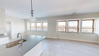 This substantial property at 328 College Ave, Lancaster, PA, offers an impressive 7,050 square feet of living space on a single floor. The layout includes 19 bedrooms, 11 bathrooms, and 5 kitchens, making it ideal for multi-unit housing or communal living arrangements. The primary bedroom is generously sized at 280 square feet.

The interior features a clean, modern aesthetic with neutral tones throughout. Bedrooms are spacious and well-lit, with large windows allowing natural light to flood the rooms. Each bedroom is equipped with ample closet space, featuring built-in shelving and hanging rods.

Bathrooms are designed with functionality and style in mind, boasting sleek fixtures, modern vanities with undermount sinks, and glass-enclosed showers. The light color palette and contemporary finishes create a fresh, inviting atmosphere.

The kitchens are a highlight of the property, showcasing modern design with white cabinetry, stainless steel appliances, and quartz countertops. Some kitchens feature islands with additional seating and storage, while others are efficiently designed for compact spaces.

Throughout the property, you'll find carpeted bedrooms for comfort, while common areas and kitchens have durable, easy-to-maintain flooring. The property also includes a utility room and multiple hallways for easy navigation of the expansive space.

With its numerous bedrooms and shared living spaces, this property is well-suited for student housing, assisted living facilities, or other communal living arrangements. The single-story layout ensures accessibility, while the modern amenities provide comfort and convenience for all residents.