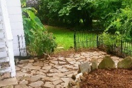 Stone patio leading to backyard - 202 S French Broad Ave