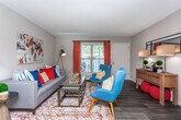 Located in Atlanta, GA, this single-floor residence offers a thoughtfully designed layout that balances functionality and comfort throughout. The galley-style kitchen is fitted with white cabinetry, dark countertops, subway tile backsplash, and stainless steel and black appliances, including a range, refrigerator, and dishwasher, all set over durable wood-look flooring. Adjacent to the kitchen, the dining area is illuminated by an overhead pendant light and includes convenient access to an in-unit washer and dryer closet. The open living room features wood-look flooring, a textured ceiling, and a large window that invites natural light, creating a warm and inviting atmosphere. Two well-sized bedrooms are finished with plush carpeting and windows with natural light. The primary bedroom includes a walk-in closet and an en-suite bathroom with a white vanity. A second full bathroom features a tub-shower combination, white vanity, and wood-look flooring. Throughout the residence, neutral wall tones provide a versatile backdrop. This home offers a practical and comfortable living environment well-suited for everyday life in Atlanta.