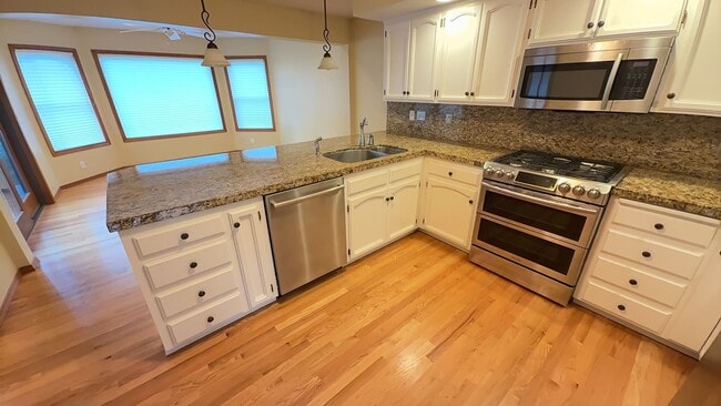 Building Photo - 4bd/3ba HUGE Home w/Hardwood Floors, Russian Fireplace, 2-Car Garage & Fenced Back Yard!