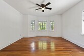 This 3-bedroom, 1-bathroom home in Birmingham, Alabama offers a practical and comfortable single-floor layout with classic character throughout. Warm hardwood floors run through the bedrooms and living areas, adding a timeless charm to the space. The generously sized primary bedroom is a standout feature, bathed in natural light from multiple windows and equipped with a ceiling fan for year-round comfort. Each of the additional bedrooms also features hardwood floors and windows that bring in natural light, with one bedroom including a built-in closet. Ceiling fans are present in several rooms, enhancing airflow and comfort. The kitchen is clean and functional, featuring light tile flooring, white cabinetry, a gas range, and a full-size refrigerator. The bathroom includes a tiled shower-tub combination with white subway tile surround and a window for natural ventilation. A connecting hallway links the rooms efficiently, contributing to a cohesive and easy-to-navigate floor plan. The home's crisp white walls throughout provide a neutral backdrop, while the classic paneled doors and traditional trim add architectural detail. This residence offers a solid combination of practicality and classic design in a well-connected Birmingham neighborhood.