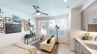 Located at 651 East 6th Street in Tempe, Arizona, this efficiently designed studio unit makes exceptional use of its compact footprint through thoughtful layout and smart storage solutions. The open-plan living area features light wood-style flooring, crisp white walls, and a ceiling fan that enhances airflow throughout. A bank of large windows fitted with blinds floods the space with natural light while offering views of the surrounding neighborhood.

The kitchen is seamlessly integrated into the living area and is equipped with stainless steel appliances — including a range, microwave, and refrigerator — complemented by light wood cabinetry, a white quartz countertop, and a subway tile backsplash. Recessed lighting overhead ensures the kitchen remains bright and functional.

A built-in Murphy bed with integrated shelving and storage cabinetry provides a versatile sleeping solution, allowing the living area to remain open and flexible when not in use. The bathroom features a full tub and shower combination with floor-to-ceiling tile surround, a wood-toned vanity with a white countertop, a large mirror, and light wood-style flooring that ties cohesively to the rest of the unit. Overall, the space presents a modern, clean aesthetic well-suited for efficient urban living in the heart of Tempe.