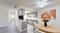 Located at 2105 E Avenue J-8 in Lancaster, CA, this single-floor, 3-bedroom, 2-bathroom unit offers a well-organized layout across a comfortable footprint. The interior features consistent wood-look flooring and textured ceilings throughout, creating a cohesive aesthetic.

The kitchen is equipped with gray cabinetry, white countertops, black appliances including a gas range and refrigerator, and a skylight that introduces natural light. It connects seamlessly to a dining area outfitted with a ceiling fan. The living room is bright and open, with a sliding glass door leading to a private balcony with outdoor views.

Two hallways connect the living areas to the three bedrooms, each featuring neutral walls, wood-look flooring, and windows with outdoor views. The spacious primary bedroom provides a comfortable retreat, while the additional bedrooms offer versatility. Four closets are distributed throughout the unit for ample storage.

The two bathrooms include one with a sliding-door walk-in shower and a second featuring a vanity with white countertops and mirrored medicine cabinets. The entryway is welcoming and open, providing a smooth transition into the main living spaces.