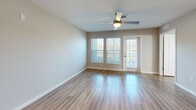Located at 5004 Dream Dr in Winter Haven, Florida, this single-story, 2-bedroom, 2-bathroom home offers a thoughtfully designed layout with modern finishes throughout. Light wood-look flooring flows consistently across every room, creating a cohesive and clean aesthetic.

The kitchen is a standout feature, showcasing white shaker-style cabinetry extending to the ceiling, granite-look countertops, a center island with an undermount sink, and a full suite of stainless steel appliances including a refrigerator, electric range, and over-the-range microwave. The kitchen opens directly into the living area, which is bathed in natural light from large windows and a glass exterior door, complemented by a ceiling fan overhead.

The spacious primary bedroom includes a generous walk-in closet outfitted with wire shelving on three walls, providing ample storage. The second bedroom features a large window with views of the surrounding greenery. Both bathrooms continue the granite countertop and white cabinetry theme — one offers a tub/shower combination with white tile surround, while the other features a dedicated walk-in shower with subway tile. A dedicated laundry room houses a full-size washer and dryer with overhead shelving for added convenience.