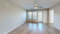 Located at 5004 Dream Dr in Winter Haven, Florida, this single-story, 2-bedroom, 2-bathroom home offers a thoughtfully designed layout with modern finishes throughout. Light wood-look flooring flows consistently across every room, creating a cohesive and clean aesthetic.

The kitchen is a standout feature, showcasing white shaker-style cabinetry extending to the ceiling, granite-look countertops, a center island with an undermount sink, and a full suite of stainless steel appliances including a refrigerator, electric range, and over-the-range microwave. The kitchen opens directly into the living area, which is bathed in natural light from large windows and a glass exterior door, complemented by a ceiling fan overhead.

The spacious primary bedroom includes a generous walk-in closet outfitted with wire shelving on three walls, providing ample storage. The second bedroom features a large window with views of the surrounding greenery. Both bathrooms continue the granite countertop and white cabinetry theme — one offers a tub/shower combination with white tile surround, while the other features a dedicated walk-in shower with subway tile. A dedicated laundry room houses a full-size washer and dryer with overhead shelving for added convenience.