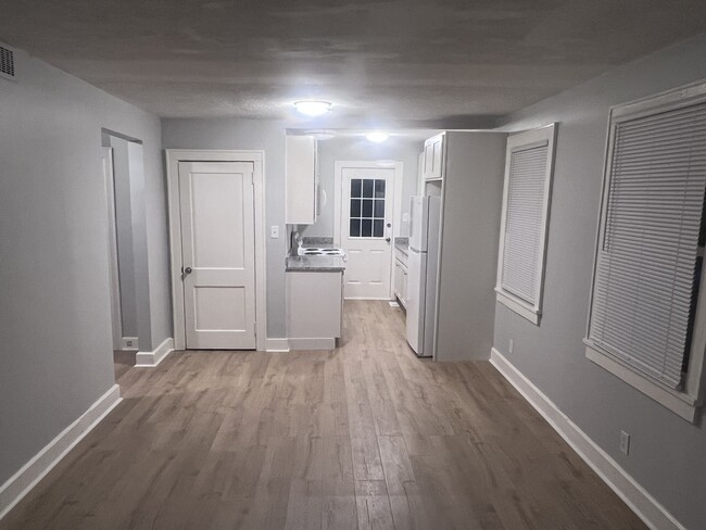 Living room into kitchen/new flooring throughout - 229 Mockingbird Dr