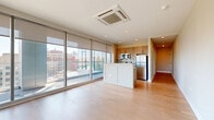 Located at 1 Race Street in the heart of Philadelphia, this modern one-bedroom, one-bathroom residence offers a thoughtfully designed layout with contemporary finishes throughout. Light hardwood flooring flows seamlessly across every room, creating a warm and cohesive aesthetic.

A welcoming hallway leads into the open-concept living and kitchen area, where expansive floor-to-ceiling glass windows and sliding doors flood the space with natural light and frame striking panoramic views of the Philadelphia skyline and surrounding cityscape. Roller shades provide privacy and light control. The living area offers a generous footprint ideal for comfortable everyday living.

The kitchen features warm wood cabinetry, a tile backsplash, granite countertops, a central island with a breakfast bar, and a full suite of stainless steel appliances including a refrigerator, electric range, and microwave. Recessed lighting and a ceiling-mounted HVAC unit provide efficient climate control.

The spacious primary bedroom continues the floor-to-ceiling window motif, offering direct access to an outdoor balcony and abundant natural light alongside sweeping city views. The full bathroom is finished with large-format tile flooring, a modern wood-toned vanity with an integrated sink, an illuminated mirror, and a glass-enclosed shower-tub combination.