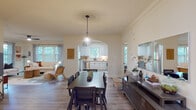 Located in Atlanta's vibrant 30306 zip code, this single-floor home at 550 Rock Springs Ct NE offers a thoughtfully designed open-concept layout that seamlessly connects the living, dining, and kitchen areas. Hardwood-style flooring flows throughout the main living spaces, complemented by crown molding and neutral tones that create a warm, cohesive aesthetic.

The kitchen is well-appointed with white cabinetry, a tile backsplash in warm earth tones, stone-look countertops, a double basin sink with a bridge-style faucet, and stainless steel appliances including a dishwasher. A window above the sink invites natural light and garden views. The kitchen connects to the dining area through a graceful arched passageway, where a pendant light anchors the generous dining space.

The living room features large windows dressed with blinds and curtains, bathing the space in natural light, while a ceiling fan adds comfort. The bedroom offers ample space, a wide window with lush tree views, and a ceiling fan. A dedicated mudroom with sage-green walls and tile flooring provides a practical entryway. An in-unit laundry room houses a full-size washer and dryer with overhead shelving. The home also features a hallway adorned with vibrant botanical artwork, adding a curated, artistic character throughout.