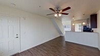 This 690 square foot townhouse in Woodstock offers a well-designed living space spread across two floors. The property features two bedrooms and two bathrooms, making efficient use of its compact footprint. The ground floor, measuring 360 square feet, houses the main living areas, while the upper floor of 330 square feet accommodates the bedrooms.

The interior showcases a modern aesthetic with a neutral color palette. The open-concept design on the main floor combines the kitchen and living room, creating a spacious feel. The kitchen boasts dark wood cabinetry, stainless steel appliances, and a practical breakfast bar, all complemented by wood-look flooring that extends throughout the common areas.

Both bedrooms are carpeted for comfort and feature ceiling fans with integrated lighting. The primary bedroom, measuring 110 square feet, provides a cozy retreat. Large windows in the bedrooms and living areas allow for ample natural light, enhancing the sense of space.

The bathrooms are designed with functionality in mind, featuring modern fixtures and finishes. One bathroom showcases wooden flooring and a expansive vanity with ample storage.

Throughout the home, recessed lighting and ceiling fans contribute to the overall ambiance and comfort. The property's layout maximizes space efficiency, making it an ideal option for those seeking a modern, low-maintenance living solution in a prime Woodstock location.