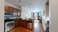 Located at 1055 Pine St in Nashville, TN, this one-bedroom, one-bathroom unit offers a well-designed open-concept layout that maximizes its comfortable footprint. Warm hardwood flooring flows throughout the main living areas, creating a cohesive and inviting atmosphere.

The kitchen is a standout feature, equipped with rich wood cabinetry, dark granite countertops, a tile backsplash, and a full suite of stainless steel appliances including a range, microwave, and dishwasher. A peninsula with seating provides a casual dining option and connects the kitchen seamlessly to the living area. Pendant lighting above the peninsula adds a polished touch.

The living room is bright and airy, benefiting from large windows that invite natural light. A glass-paneled entry door with a transom window further enhances the sense of openness.

The bedroom is a calm retreat featuring large windows with outdoor views, hardwood flooring, and a neutral color palette that promotes a restful environment.

The bathroom offers a dark-toned vanity with granite countertops, tile flooring, and a shower-tub combination. A hallway with additional door access provides functional separation between living and private spaces.

This unit combines practical design with quality finishes throughout.