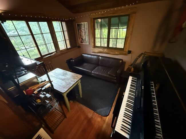 Comfortable living room / office with piano and large windows overlooking the estate - 20 Victoria Way