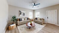 This contemporary 1030 square foot residence in Biloxi, MS offers a thoughtfully designed single-story layout. The home boasts two bedrooms, including a spacious 180 square foot primary suite, and two full bathrooms. The heart of the home is an open-concept living area, seamlessly connecting the living room, dining room, and kitchen. The gourmet kitchen features crisp white cabinetry, stainless steel appliances, and ample counter space, ideal for culinary enthusiasts. A dedicated office provides a quiet workspace, while the in-unit laundry adds convenience. The interior showcases a neutral color palette with warm wood floors throughout, creating a cohesive and inviting ambiance. Modern amenities include ceiling fans and updated lighting fixtures. Large windows in the living areas and bedrooms allow natural light to flood the space, enhancing the airy feel. The bathrooms are elegantly appointed with contemporary fixtures and finishes. This turnkey property at 1735 Tribe Dr offers a perfect blend of style, functionality, and comfort in a desirable Biloxi location.