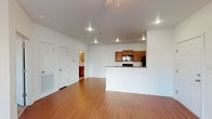 This 1-bedroom, 1-bathroom unit is laid out entirely on a single floor, offering a practical and cohesive flow throughout the space. The open-concept living area is bright and welcoming, featuring warm hardwood-style flooring, recessed lighting, and a ceiling fan. A peninsula counter seamlessly connects the kitchen to the main living space, making the layout feel open and connected. The kitchen is well-appointed with rich medium-toned wood cabinetry, granite-style countertops, and black appliances including a range, over-the-range microwave, refrigerator, and dishwasher. Ample upper and lower cabinet storage ensures functional everyday use. The living area benefits from a sliding glass door fitted with vertical blinds, allowing natural light to fill the room. The bedroom is carpeted for comfort, includes a ceiling fan, and features a window that brings in additional natural light. The bathroom is clean and efficiently designed, offering a tub-shower combination, a wall-mounted storage cabinet, tile flooring, and crisp white fixtures. Throughout the unit, the neutral color palette and consistent finishes create a cohesive and move-in-ready environment suited for comfortable everyday living.