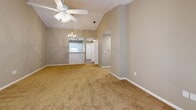 Located in Foley, Alabama, this 2-bedroom, 2-bathroom single-story home offers a well-designed layout with comfortable living spaces throughout. The open living room is a standout feature, boasting vaulted ceilings, plush carpeting, a ceiling fan with light fixture, and a tiled fireplace flanked by French doors that lead to a private outdoor deck — filling the space with natural light and greenery views. An elegant chandelier accents the transition into the adjacent kitchen area.

The galley-style kitchen is thoughtfully appointed with crisp white cabinetry, light countertops, a tiled backsplash, wood-look flooring, and black appliances including a range, microwave, refrigerator, and dishwasher, along with a stainless steel sink.

The primary bedroom offers generous proportions with vaulted ceilings, a ceiling fan, soft carpet, a large window with outdoor views, and two spacious closets. The second bedroom also features plush carpet, a ceiling fan, and a bright window with natural light. Both bathrooms are equipped with full tub/shower combos and clean, neutral finishes. A connecting hallway ties the layout together efficiently, completing this inviting home.