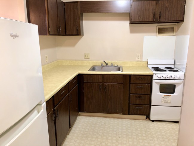 Kitchen with Ample Storage and Counter Space - Riverview Apartments