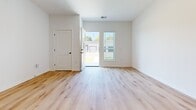 This expansive 3,050 square foot apartment in Hartland, WI, offers a harmonious blend of space and modern design. The open-concept layout creates a seamless flow between the living areas, enhancing the sense of spaciousness. Light wood flooring runs throughout, providing warmth and continuity to the space.

The kitchen is a standout feature, boasting white cabinetry, stainless steel appliances, and a generous island with a granite countertop. Pendant lighting adds a touch of contemporary style. The living area is bathed in natural light from large windows, creating an inviting atmosphere.

The bedroom, measuring 140 square feet, offers ample space and features a large window for natural illumination. The bathroom is well-appointed with a glass-enclosed shower, modern fixtures, and built-in storage.

High ceilings and crisp white walls contribute to the apartment's airy feel. The entryway features a sliding barn door, adding a touch of rustic charm to the otherwise contemporary space. Multiple windows throughout ensure the apartment is filled with natural light, while offering views of the surrounding area.

This apartment combines functionality with style, creating an ideal living space for those who appreciate modern design and spacious interiors.