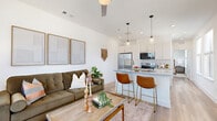 Located in Austin, TX, this one-bedroom, one-bathroom unit offers a well-designed open-concept layout that maximizes every square foot of its compact footprint. The combined kitchen and living area serves as the heart of the home, where light wood-style flooring flows continuously underfoot, creating a cohesive and airy feel throughout. The kitchen is outfitted with crisp white shaker-style cabinetry, granite countertops, a subway tile backsplash, and a full suite of stainless steel appliances, including a refrigerator, range, and over-the-range microwave. A peninsula with seating for two anchors the space, while pendant lighting above adds a modern finishing touch. The living area benefits from large windows that invite abundant natural light and offer outdoor views, complemented by a ceiling fan overhead. The bedroom is a comfortable retreat featuring a double-door closet, a ceiling fan, and multiple windows that provide ample natural light and exterior views. The bathroom maintains the same refined aesthetic with granite countertops, white cabinetry, wood-style flooring, and a walk-in shower, keeping the design consistent and polished. Overall, the unit presents a clean, contemporary interior well-suited for efficient urban living in East Austin.