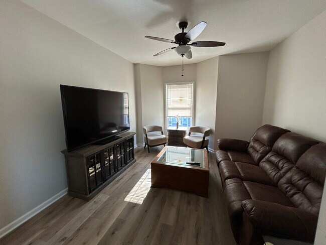 70 inch TV, coffee table, and couch included - 1449 W 50th St